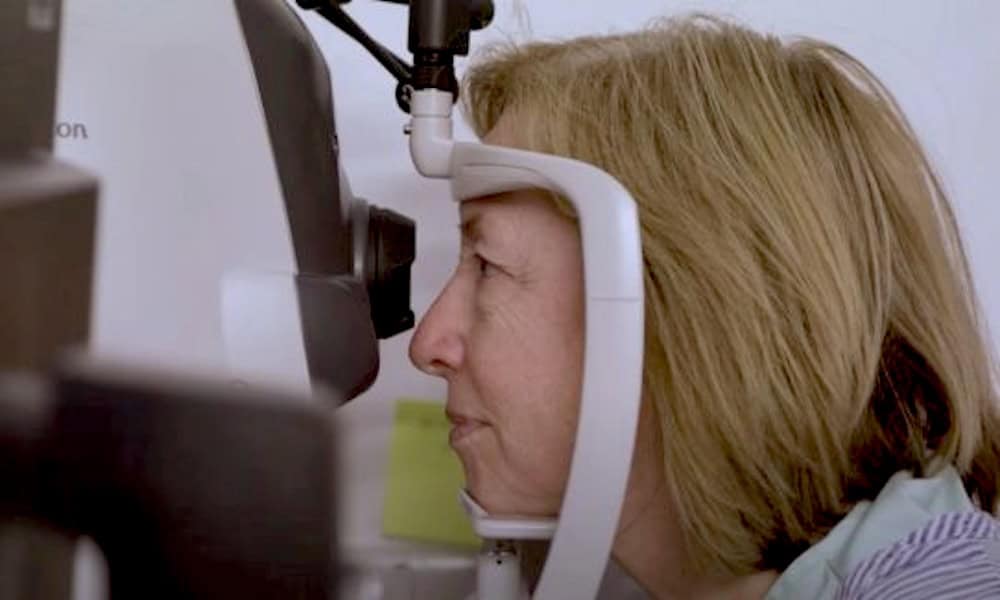 A woman has an OCT scan on her eye