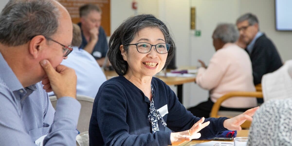 A member of the Participant Advisory Group explains a point whilst others listen in