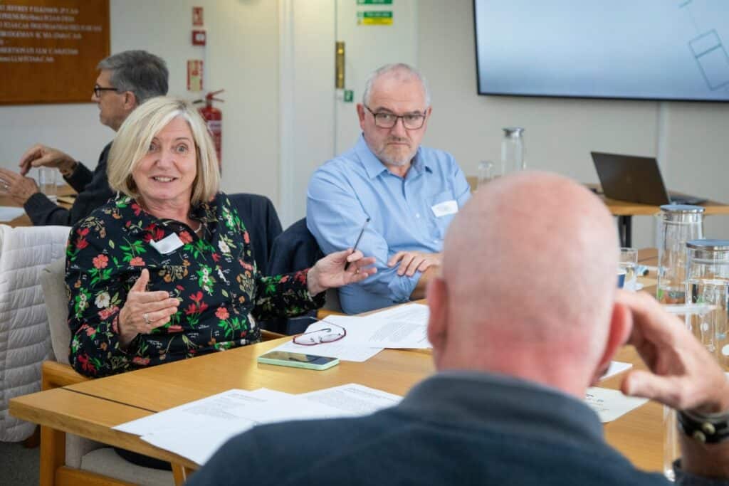 Members of the Participant Advisory Group have a discussion round a table