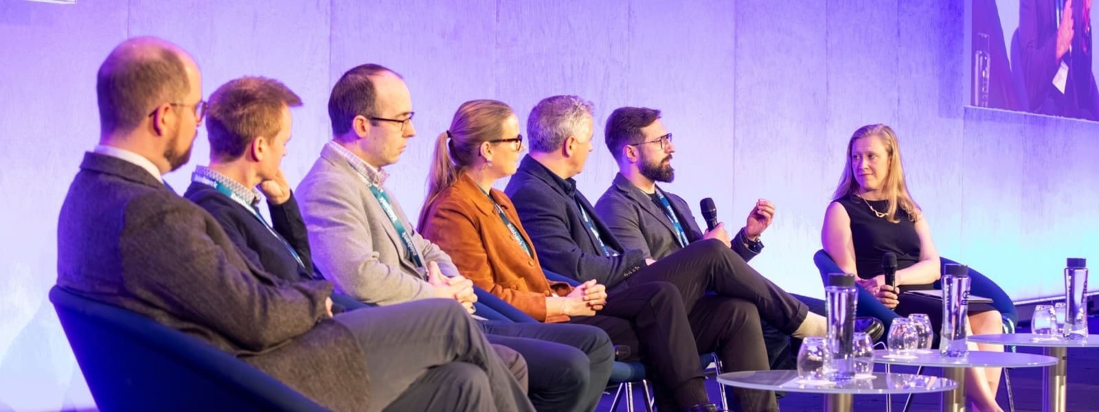 Panel members look on as one panel member speaks into a microphone, at the UK Biobank Scientific Conference 2025